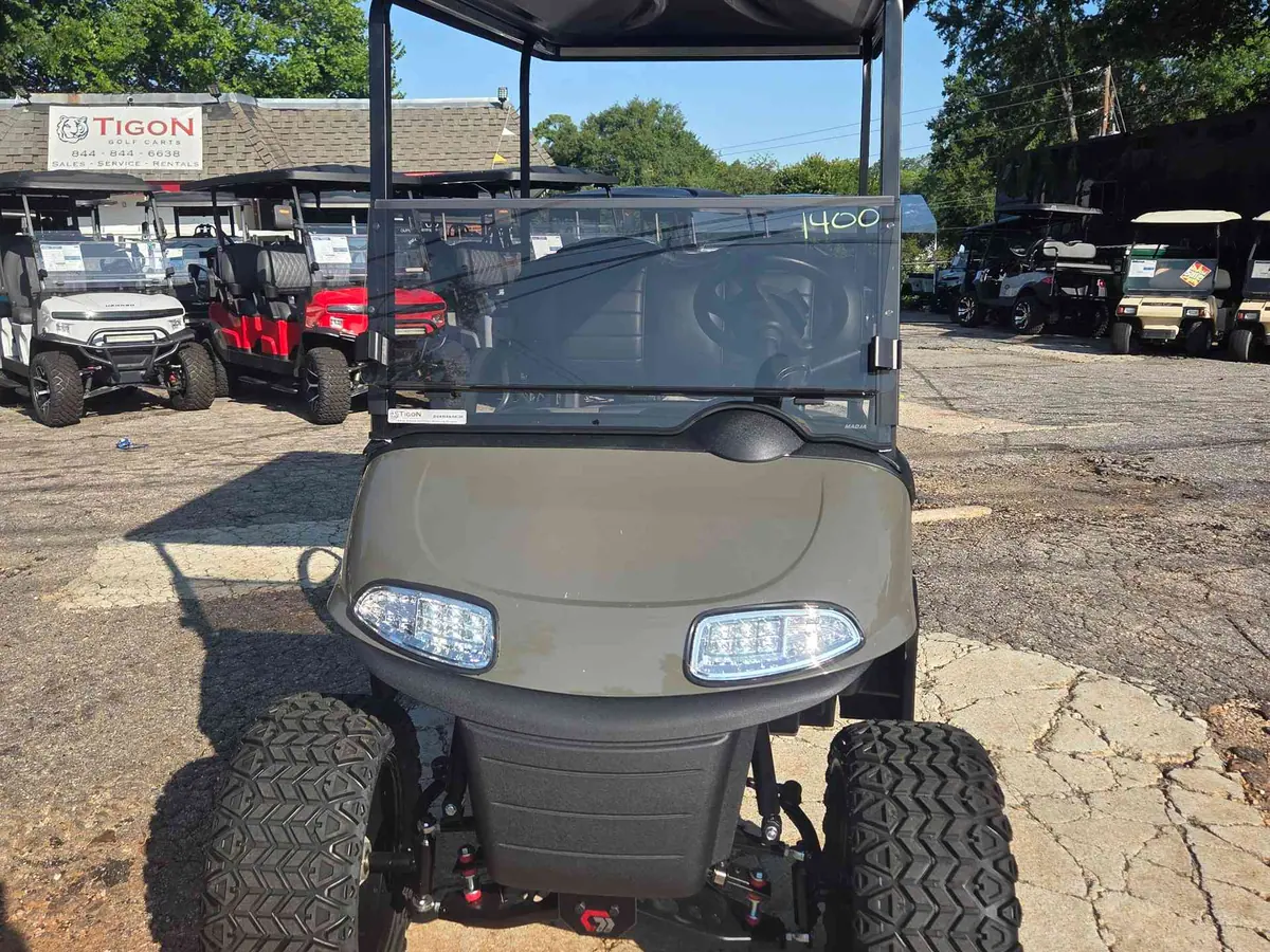 Used beige electric 2021 EZGO RXV lifted golf cart for sale in Raleigh, NC