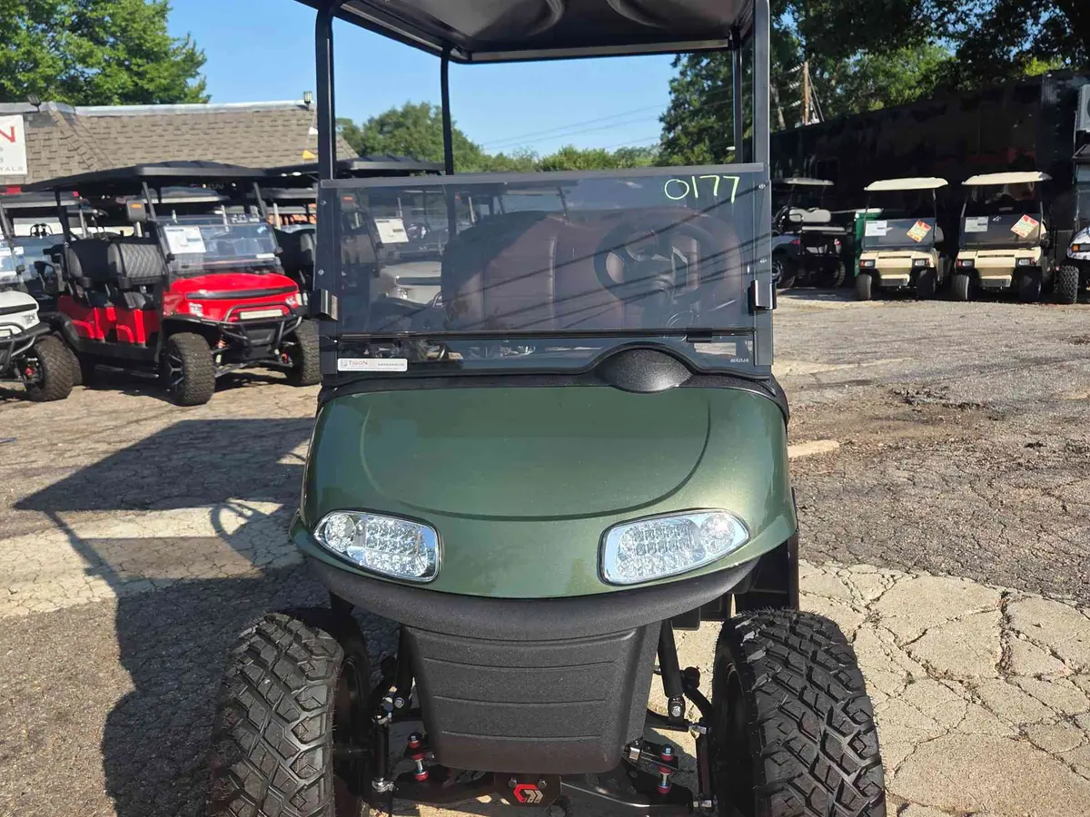 Used green electric 2021 EZGO RXV lifted golf cart for sale in Raleigh, NC