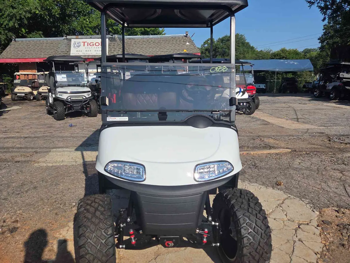Used white electric 2021 EZGO RXV lifted golf cart for sale in Raleigh, NC